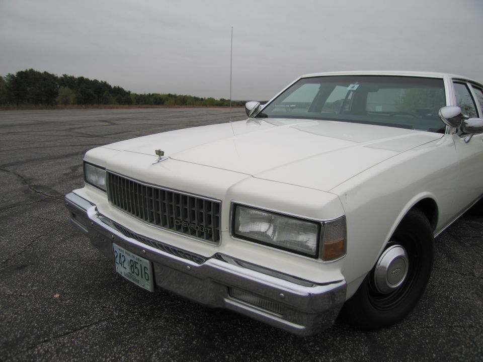 White 1991 Chevrolet Caprice sedan, front 3/4 view. License plate 242 8516