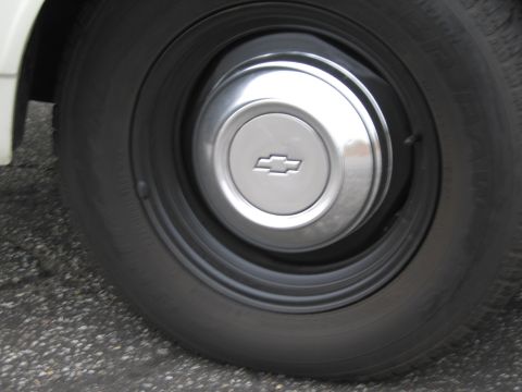 1991 Ford LTD Crown Victoria - Close-up of a Chevrolet hubcap on a vehicle's tire.