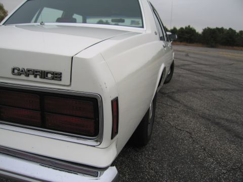1991 Ford LTD Crown Victoria - The rear badging clearly reads 'Caprice' on this white sedan.