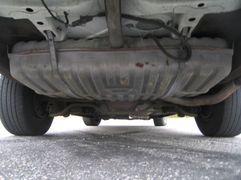 1991 Ford LTD Crown Victoria - Underside view of a car, focusing on the fuel tank and exhaust components.