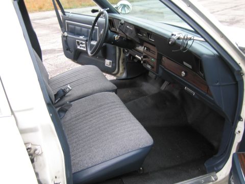 1991 Ford LTD Crown Victoria - Interior view of a car showing the front seats, dashboard, and steering wheel.