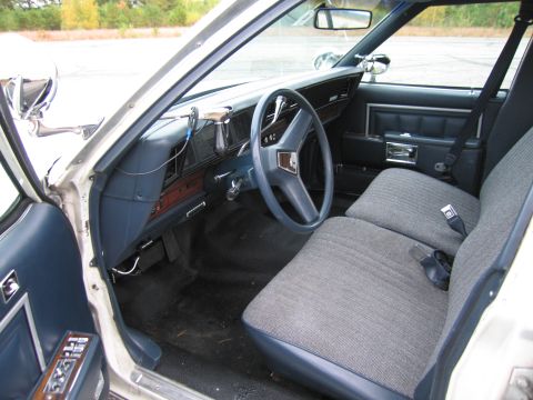 1991 Ford LTD Crown Victoria - The interior of a car shows the dashboard, steering wheel, and front seats.