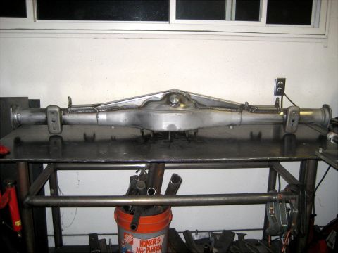1996 Ford Bronco - Custom fabricated rear axle assembly shown on a workbench, likely for a custom vehicle project.