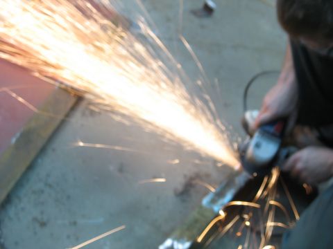 1900 Ford C-350 (Centurion Conversions) - Sparks fly as metal is being cut with an angle grinder.