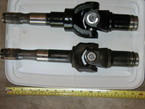 1995 Ford Bronco - Two driveshaft components are shown side-by-side with a measuring tape for scale.