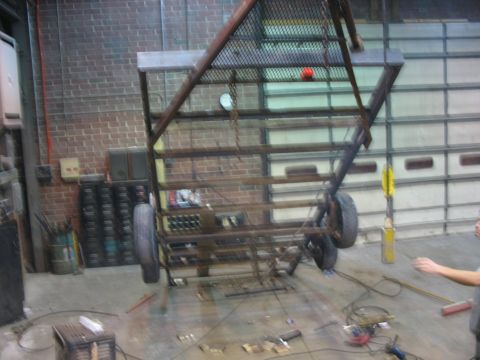 1900 Ford C-350 (Centurion Conversions) - Custom trailer frame being worked on in a workshop environment.