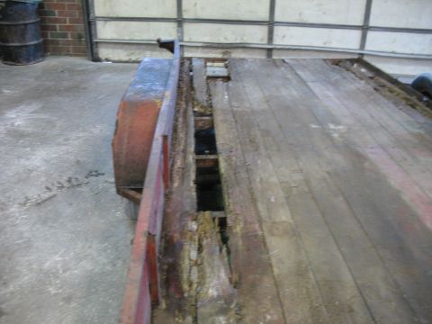 1900 Ford C-350 (Centurion Conversions) - Trailer deck shows significant rot and damage to the wooden planks and metal supports.