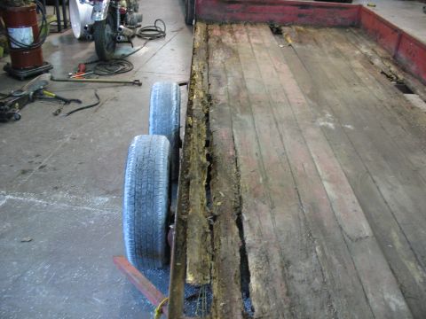 1900 Ford C-350 (Centurion Conversions) - The wooden deck of this trailer is severely damaged and appears to be rotting.