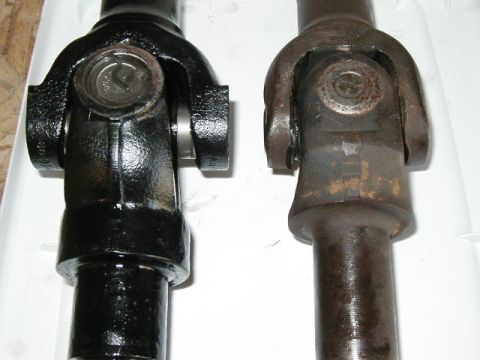 1995 Ford Bronco - Comparison of a new black driveshaft yoke next to an older, rusted one.