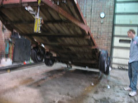 1900 Ford C-350 (Centurion Conversions) - Trailer being lifted by a crane in a workshop setting.