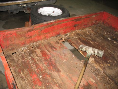 1900 Ford C-350 (Centurion Conversions) - Trailer bed shows significant rust and damage, with a shovel lying across the opening.