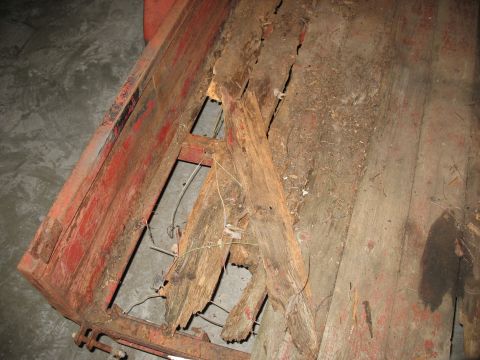 1900 Ford C-350 (Centurion Conversions) - The wooden bed of this truck shows significant rot and damage to its planks and supporting structure.