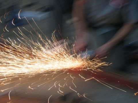 1900 Ford C-350 (Centurion Conversions) - Grinding metal generates a bright shower of sparks.