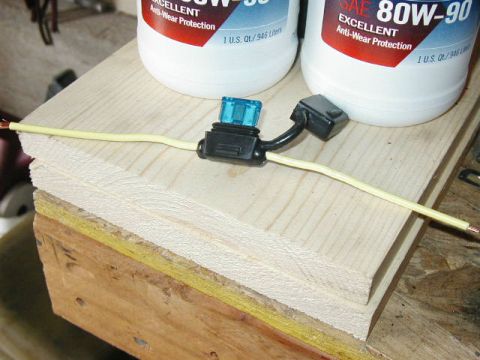 1995 Ford Bronco - An inline fuse holder with a blue fuse is shown, along with two bottles of SAE 80W-90 oil.