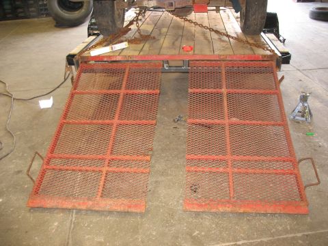 1900 Ford C-350 (Centurion Conversions) - Trailer ramps and a tire on a trailer, ready for loading.