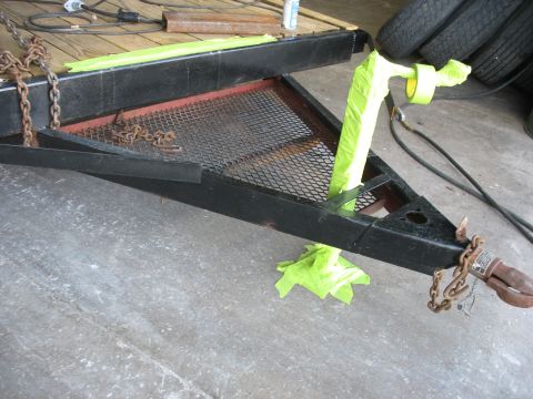 1900 Ford C-350 (Centurion Conversions) - Close-up of a trailer hitch assembly, showing chains and masking tape.