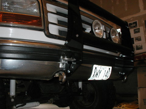 1995 Ford Bronco - Front view of a 1995 Ford Bronco, its grille, bumper, and a brush guard with auxiliary lights.