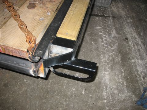 1900 Ford C-350 (Centurion Conversions) - Close-up of a trailer frame, showing construction details and a rusty chain.