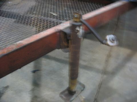 1900 Ford C-350 (Centurion Conversions) - A close-up view of a trailer's mechanical jack mechanism.