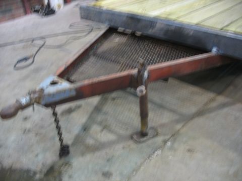1900 Ford C-350 (Centurion Conversions) - Close-up view of a trailer hitch and jack mechanism, with a metal mesh deck visible.