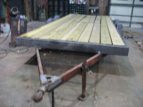 1900 Ford C-350 (Centurion Conversions) - Trailer with a wooden deck in a workshop setting.
