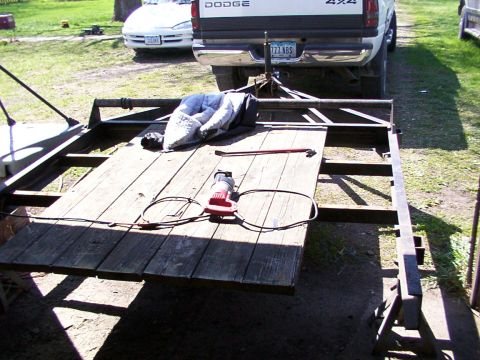1900 Ford C-350 (Centurion Conversions) - A trailer is parked outdoors with a white Dodge truck and a car visible in the background.