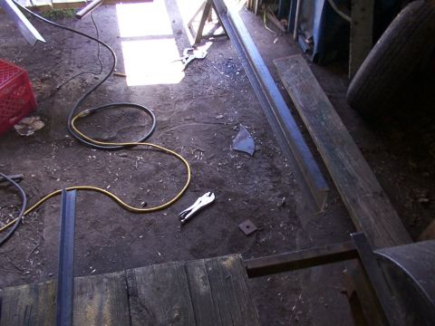 1900 Ford C-350 (Centurion Conversions) - A cluttered workshop scene with various tools and construction materials scattered on the ground.