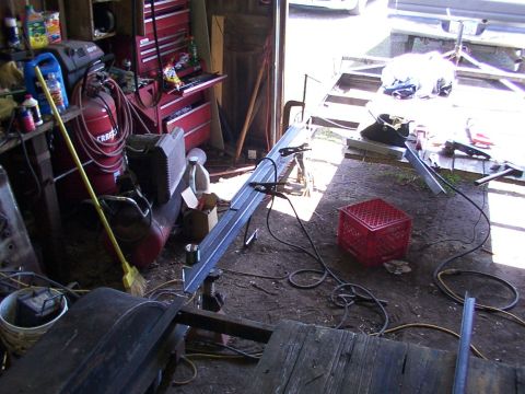 1900 Ford C-350 (Centurion Conversions) - Workshop scene with various tools and metal fabrication in progress.