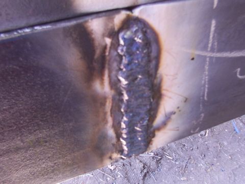 1900 Ford C-350 (Centurion Conversions) - A close-up view of a weld seam on a metal panel, showing signs of repair or construction.