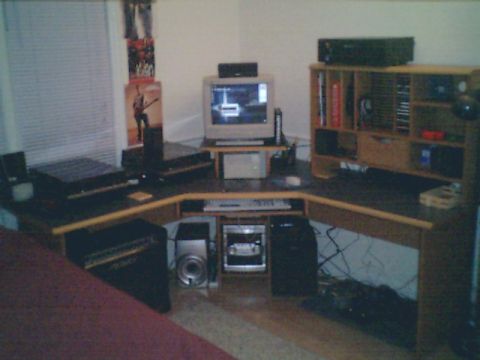 1998 Ford Taurus - A cluttered desk area features a CRT monitor and various electronic components.