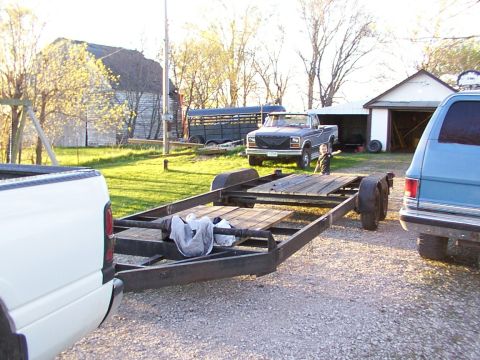 1900 Ford C-350 (Centurion Conversions) - Pickup truck and trailer parked in a yard with a barn and garage in the background.