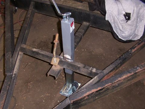 1900 Ford C-350 (Centurion Conversions) - A trailer frame is shown with a jack and a rusty bracket attached.