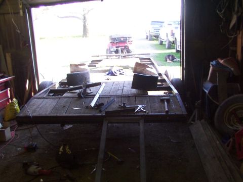 1900 Ford C-350 (Centurion Conversions) - Trailer frame construction in progress, with other vehicles and equipment visible in the background.
