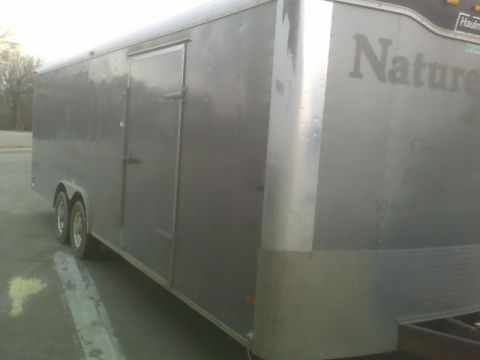 1900 Ford C-350 (Centurion Conversions) - Side view of a gray enclosed cargo trailer with text visible on the side panel.
