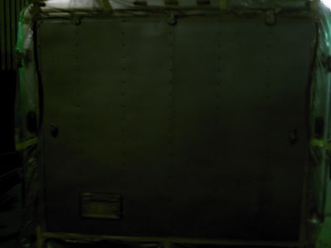 1900 Ford C-350 (Centurion Conversions) - Rear view of an enclosed vehicle or cargo container, wrapped for transport.