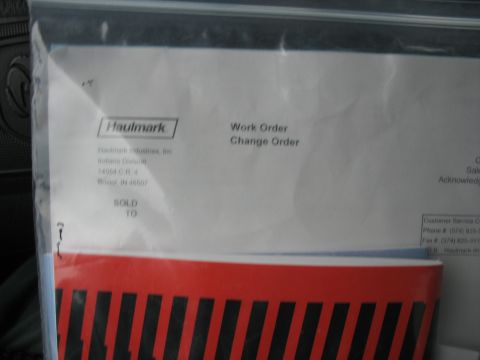 1900 Ford C-350 (Centurion Conversions) - A document is shown inside a plastic sleeve, with a red and black striped pattern visible at the bottom.