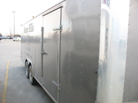 1900 Ford C-350 (Centurion Conversions) - A silver enclosed cargo trailer is parked in a lot, showing its side door and branding.