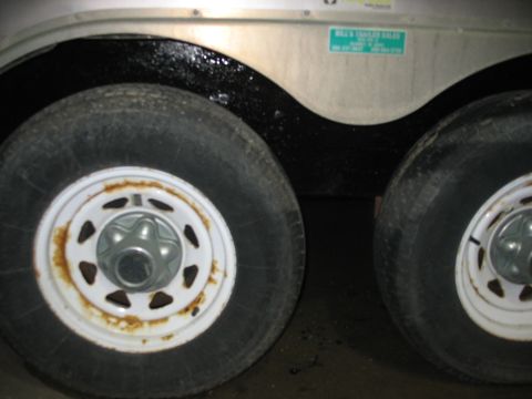 1900 Ford C-350 (Centurion Conversions) - Close-up of trailer wheels and fender, showing a sticker for Billy's Trailer Sales.