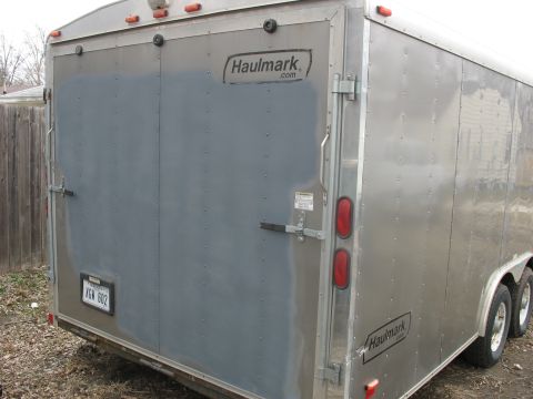 1900 Ford C-350 (Centurion Conversions) - Rear view of a silver enclosed trailer, Haulmark branding and a license plate.