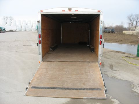 1900 Ford C-350 (Centurion Conversions) - An empty cargo trailer with its ramp lowered, ready for loading or unloading.