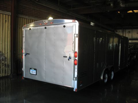 1900 Ford C-350 (Centurion Conversions) - Silver enclosed trailer with dual axles is viewed from the rear. The license plate reads 5808 CK.