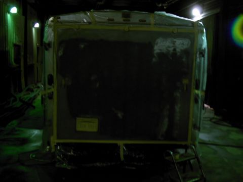 1900 Ford C-350 (Centurion Conversions) - Rear view of a large, covered vehicle or trailer, possibly in storage or transit.