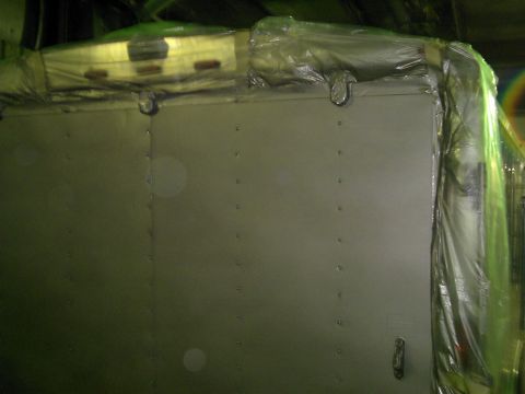 1900 Ford C-350 (Centurion Conversions) - The rear of a cargo trailer, partially covered in plastic, is visible in this image.