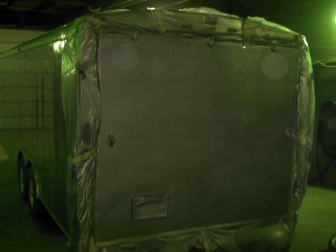 1900 Ford C-350 (Centurion Conversions) - This enclosed trailer is covered in plastic, likely for protection during a paint job or storage.