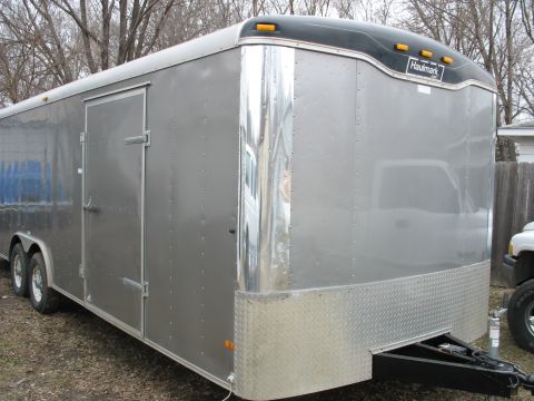 1900 Ford C-350 (Centurion Conversions) - Silver enclosed cargo trailer with 'Haulmark' branding. A pickup truck is visible on the right side.