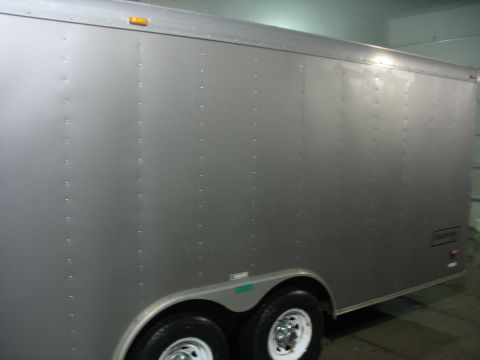 1900 Ford C-350 (Centurion Conversions) - This enclosed cargo trailer has a silver exterior with visible rivets along the side panels.