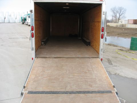 1900 Ford C-350 (Centurion Conversions) - Rear view of an empty cargo trailer with its ramp extended, parked on a concrete surface.
