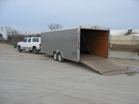 1900 Ford C-350 (Centurion Conversions) - White Ford Bronco SUV towing a silver cargo trailer on a cloudy day.