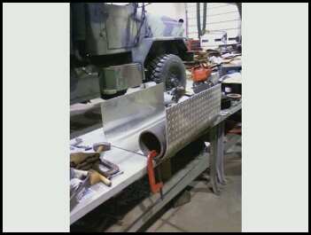1996 Ford Bronco - Metal fabrication in progress on a workbench, with tools and materials visible.