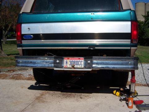 1996 Ford Bronco - The rear of a 1996 Ford Bronco, its distinctive teal and silver two-tone paint scheme and chrome bumper.